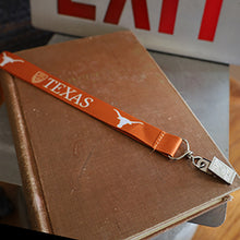 Load image into Gallery viewer, 24&quot; Orange Lanyard imprinted with white University of Texas logo and Longhorn silhouette